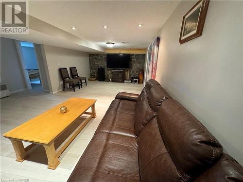 Living room with hardwood / wood-style flooring and a wood stove - 3877 Hwy 17 E, Mattawa, ON - Indoor