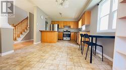 Kitchen with appliances with stainless steel finishes, an inviting chandelier, and sink - 