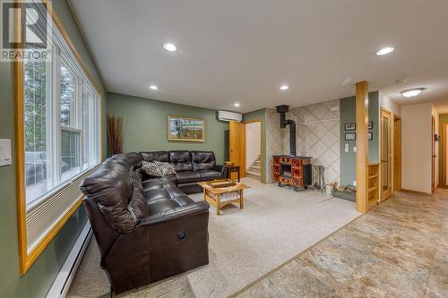 View of living area from door to deck - 4880 James Street, Fairmont Hot Springs, BC - Indoor Photo Showing Other Room With Fireplace