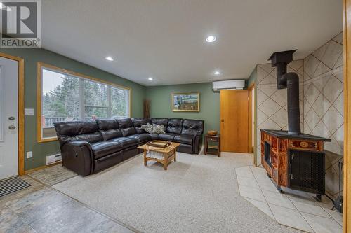 Living area (door to deck just visible on left) - 4880 James Street, Fairmont Hot Springs, BC - Indoor With Fireplace