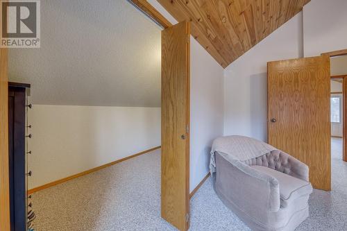 Seating area in bedroom 3 - and large walk-in closet - 4880 James Street, Fairmont Hot Springs, BC - Indoor Photo Showing Other Room