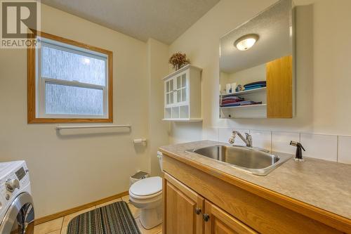 Half-bathroom and laundry room combined - 4880 James Street, Fairmont Hot Springs, BC - Indoor Photo Showing Laundry Room