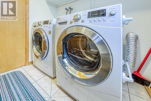 Half-bathroom and laundry room combined - 4880 James Street, Fairmont Hot Springs, BC - Indoor Photo Showing Laundry Room