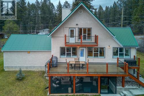 Rear elevation showing deck and screened-in patio - 4880 James Street, Fairmont Hot Springs, BC - Outdoor