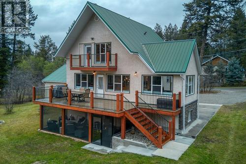 Rear elevation, deck and screened-in patio - 4880 James Street, Fairmont Hot Springs, BC - Outdoor With Deck Patio Veranda