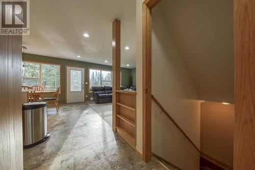 View from the entrance lobby through to the living area - steps to the basement on the right - 4880 James Street, Fairmont Hot Springs, BC - Indoor Photo Showing Other Room