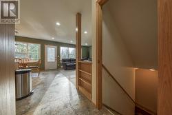 View from the entrance lobby through to the living area - steps to the basement on the right - 