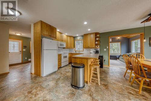 View from living area looking to kitchen, dining and den - 4880 James Street, Fairmont Hot Springs, BC - Indoor