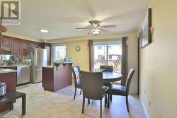 Dining area with a textured ceiling, plenty of natural light, and ceiling fan - 