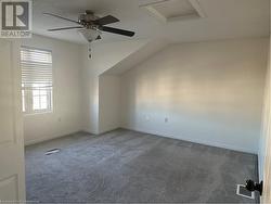 Additional living space with ceiling fan, carpet floors, and vaulted ceiling - 