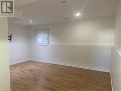 Empty room with dark wood-type flooring - 