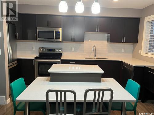 1 4545 Delhaye Way, Regina, SK - Indoor Photo Showing Kitchen With Stainless Steel Kitchen With Double Sink With Upgraded Kitchen