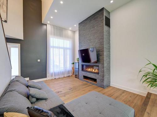 Living room - 650 Mtée Du Village, Saint-Joseph-Du-Lac, QC - Indoor Photo Showing Living Room With Fireplace