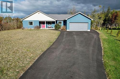 Ranch-style home with a porch, a garage, and a front lawn - 1 Williamson Place, South Bruce Peninsula, ON - Outdoor