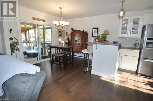 Dining area with dark engineered hardwood  crown molding, and a chandelier - 1 Williamson Place, South Bruce Peninsula, ON - Indoor