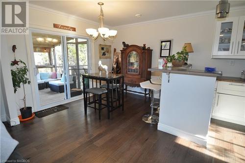 Dining space featuring ornamental molding, dark wood-type flooring, and a chandelier - 1 Williamson Place, South Bruce Peninsula, ON - Indoor Photo Showing Dining Room