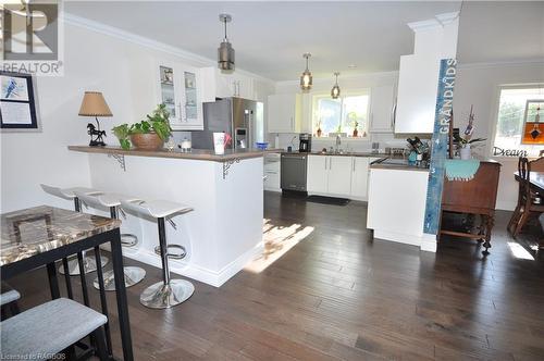 Kitchen featuring white cabinets, appliances with stainless steel finishes, kitchen peninsula, and a healthy amount of sunlight - 1 Williamson Place, South Bruce Peninsula, ON - Indoor