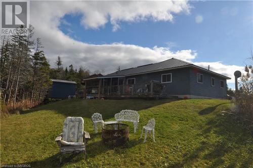 Back of house featuring a yard and a wooden deck, fire pit - 1 Williamson Place, South Bruce Peninsula, ON - Outdoor With Deck Patio Veranda