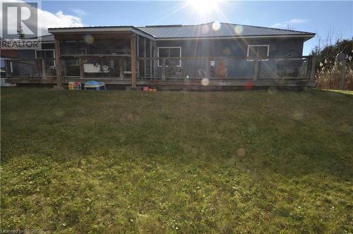 Rear view of house featuring a yard and a sunroom - 1 Williamson Place, South Bruce Peninsula, ON - Outdoor With Deck Patio Veranda