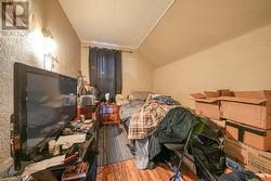 Miscellaneous room with hardwood / wood-style floors and lofted ceiling - 