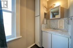 Bathroom with vanity and tasteful backsplash - 