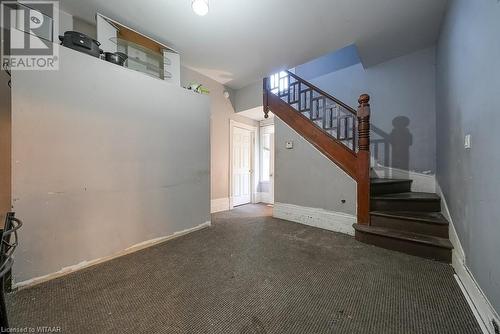 Unfurnished living room with dark colored carpet - 742 Dundas Street, Woodstock, ON - Indoor Photo Showing Other Room