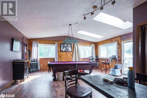 Game room featuring pool table, a wealth of natural light, wood-type flooring, and lofted ceiling with skylight - 48 North Trent Street, Frankford, ON - Indoor Photo Showing Other Room