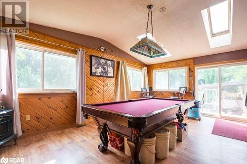 Recreation room with light hardwood / wood-style floors, lofted ceiling with skylight, wooden walls, and billiards - 48 North Trent Street, Frankford, ON - Indoor Photo Showing Other Room