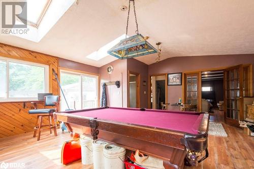 Rec room featuring wooden walls, wood-type flooring, lofted ceiling with skylight, and pool table - 48 North Trent Street, Frankford, ON - Indoor Photo Showing Other Room