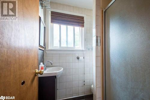 Bathroom featuring vanity, an enclosed shower, toilet, and tile walls - 48 North Trent Street, Frankford, ON - Indoor Photo Showing Bathroom