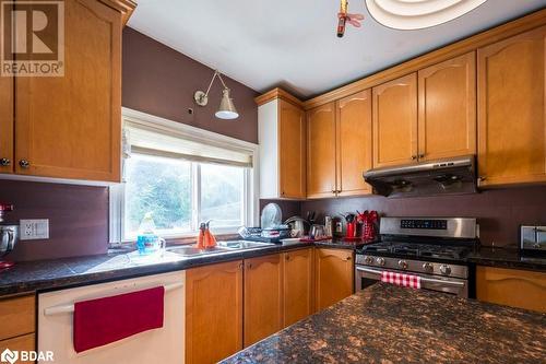 Kitchen featuring backsplash, sink, white dishwasher, and gas range - 48 North Trent Street, Frankford, ON - Indoor Photo Showing Kitchen With Double Sink