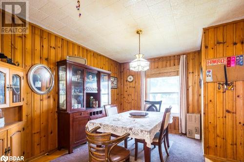 Carpeted dining space with wooden walls - 48 North Trent Street, Frankford, ON - Indoor Photo Showing Dining Room