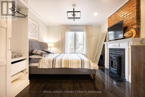 33 Beatrice Street, Toronto, ON - Indoor Photo Showing Bedroom With Fireplace