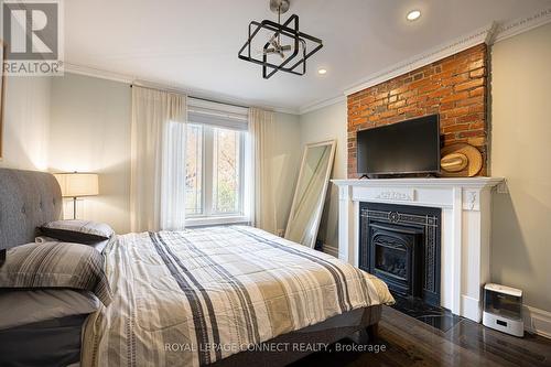 33 Beatrice Street, Toronto, ON - Indoor Photo Showing Bedroom With Fireplace