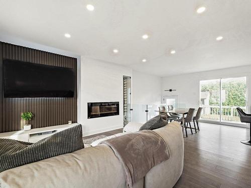 Vue d'ensemble - 3980 Crois. Bazin, Brossard, QC - Indoor Photo Showing Living Room With Fireplace