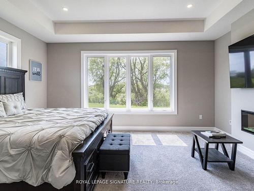 11 Whitcombe Way, Puslinch, ON - Indoor Photo Showing Bedroom With Fireplace