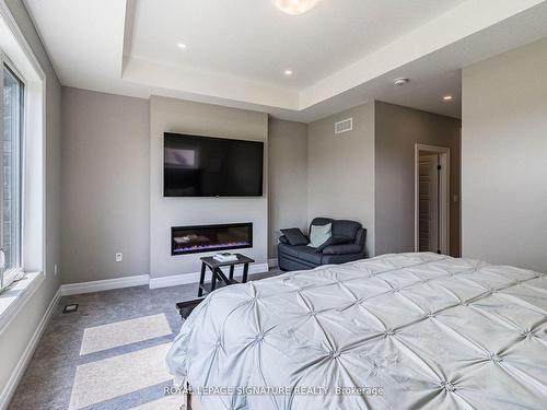 11 Whitcombe Way, Puslinch, ON - Indoor Photo Showing Bedroom With Fireplace