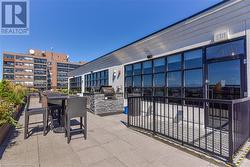 View of patio featuring an outdoor kitchen and a grill - 