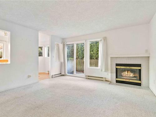 102-1801 Fern St, Victoria, BC - Indoor Photo Showing Living Room With Fireplace