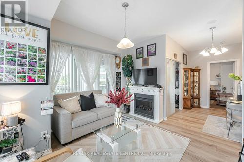 304 - 215 Queen Street E, Brampton, ON - Indoor Photo Showing Living Room With Fireplace