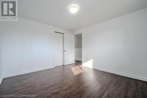 Empty room with dark wood-type flooring - 175 Cedarbrae Avenue, Waterloo, ON - Indoor Photo Showing Other Room