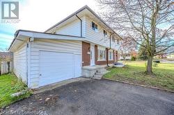 View of front facade featuring a garage and a front lawn - 