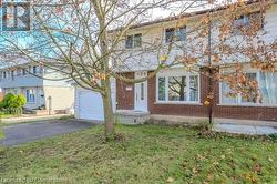 View of front of house featuring a garage and a front lawn - 