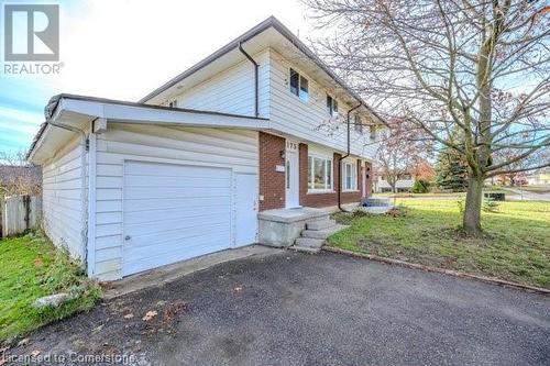 View of front facade featuring a garage and a front lawn - 175 Cedarbrae Avenue, Waterloo, ON - Outdoor