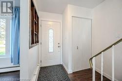 Entryway featuring plenty of natural light, dark hardwood / wood-style floors, and a baseboard heating unit - 