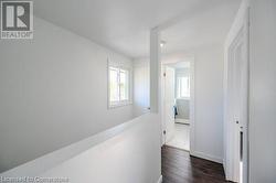 Hallway with dark wood-type flooring - 