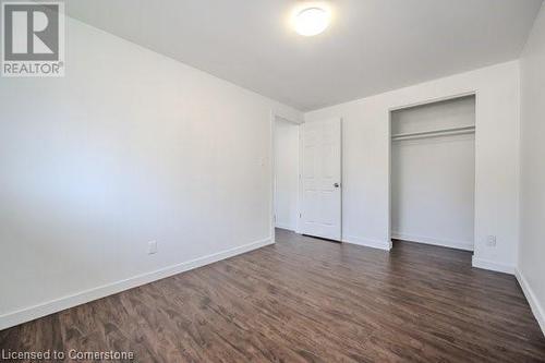 Unfurnished bedroom featuring a closet and dark hardwood / wood-style flooring - 175 Cedarbrae Avenue, Waterloo, ON - Indoor Photo Showing Other Room