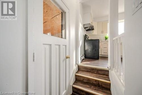 Stairway featuring wood-type flooring and baseboard heating - 175 Cedarbrae Avenue, Waterloo, ON - Indoor Photo Showing Other Room