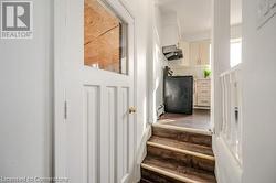 Stairway featuring wood-type flooring and baseboard heating - 