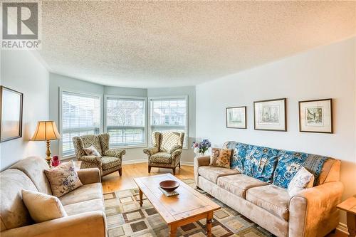 Living room w/beautiful bay window ... - 51 Decaria Boulevard, Perth, ON - Indoor Photo Showing Living Room